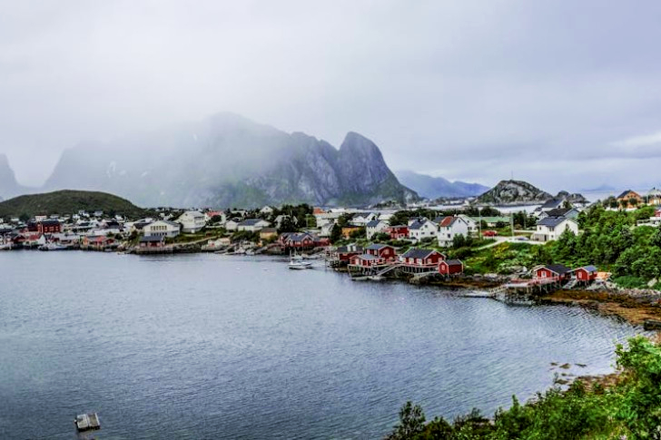 Rocky Mountain Near Citizen Houses Near Body Of Water