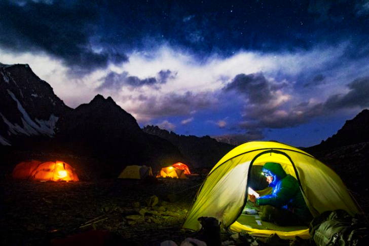 A Man In Blue Jacket In A Dome Tent