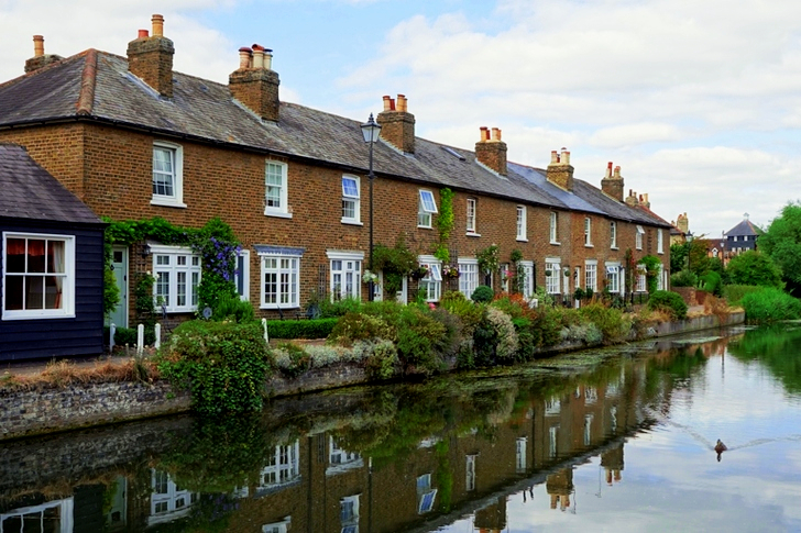 Brown Painted House in Front of Body of Water