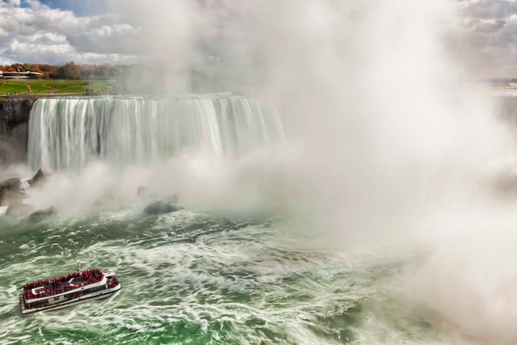 Boat Near Waterfalls during Daytime