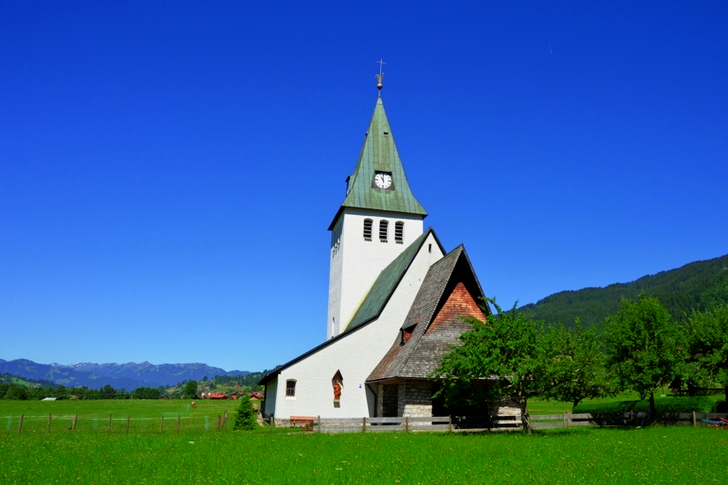 White and Gray Painted Chapel Near Green Open Field during Daytime