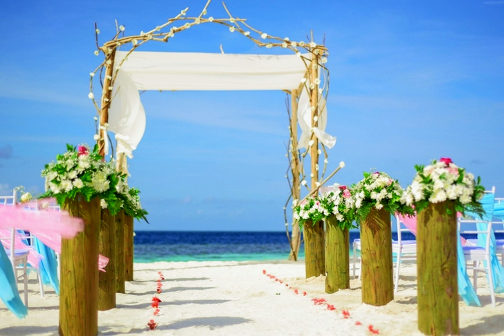 Line of White Flowers-topped Brown Wooden Pillars