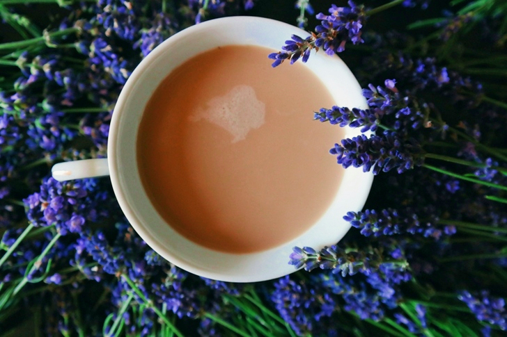 Coffee Filled on Mug Surrounded by Purple Flowers
