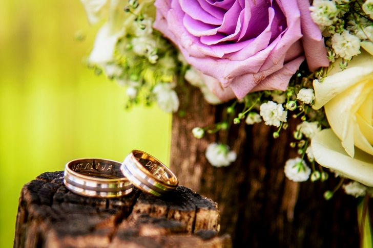 Wedding Rings Near Purple Rose