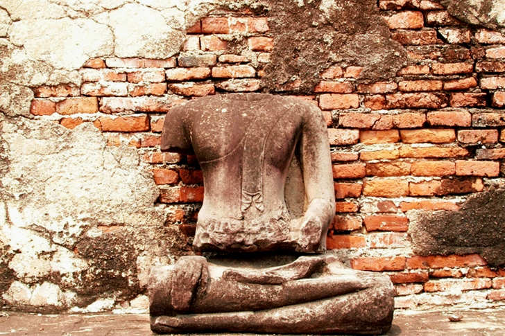 Headless Statue Sited in Front of Wall