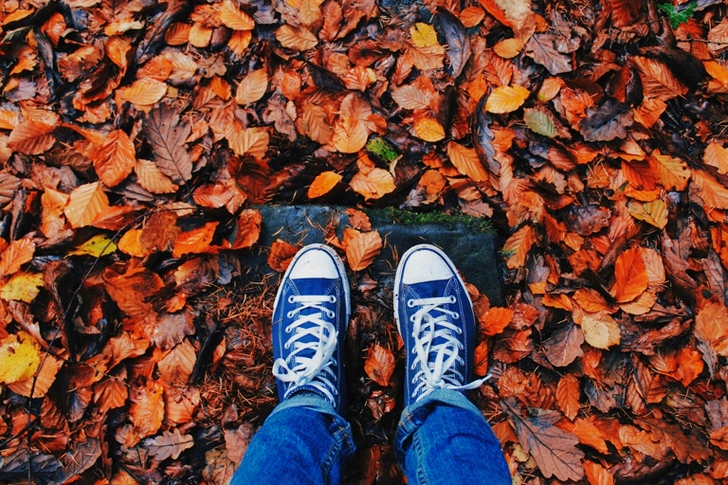 Person in Blue Jeans and Pair of Blue Sneakers
