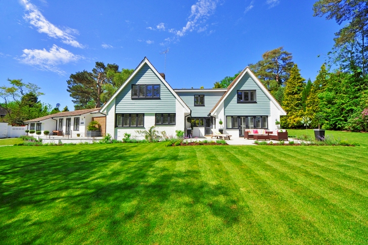 White and Gray Wooden House Near Grass Field and Trees