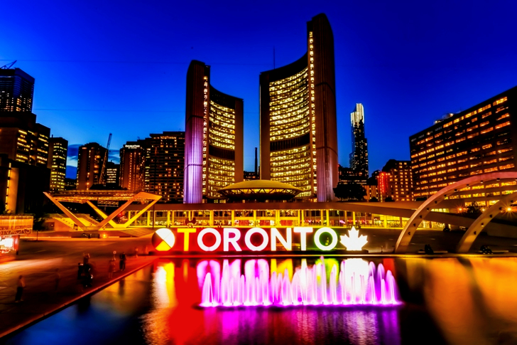 Powered-on Toronto Neon Sign Near Water Fountain