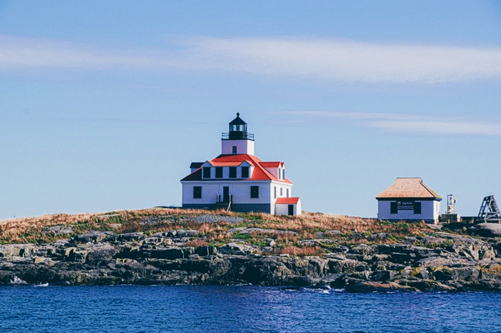 White and Red Concrete House Beside Sea
