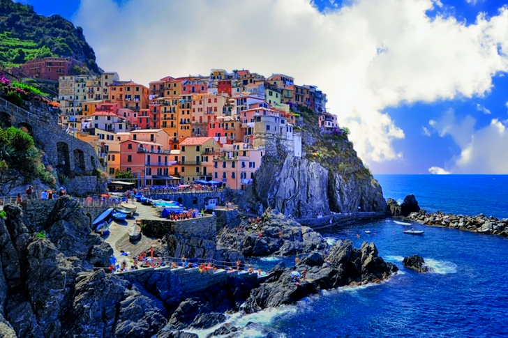 Assorted-color Houses Beside Body of Water
