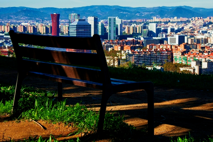 Brown Wooden Bench With Metal Frame Surrounded by Building Scenery