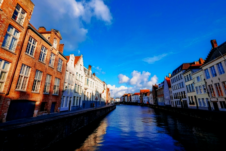 White Concrete Storey Building Near Body of Water