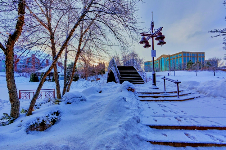 Bridge Near Light Post With Snow and Building at Distance