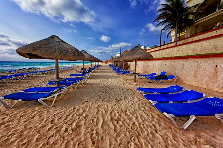 Blue and White Outdoor Chaise Lounges and Nipa Hut Beside Seashore