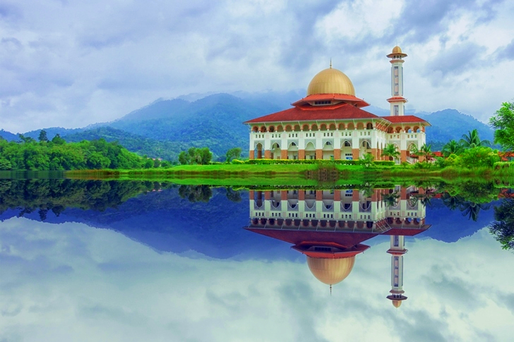 White and Red House Reflecting on Body of Water Under Blue Sky