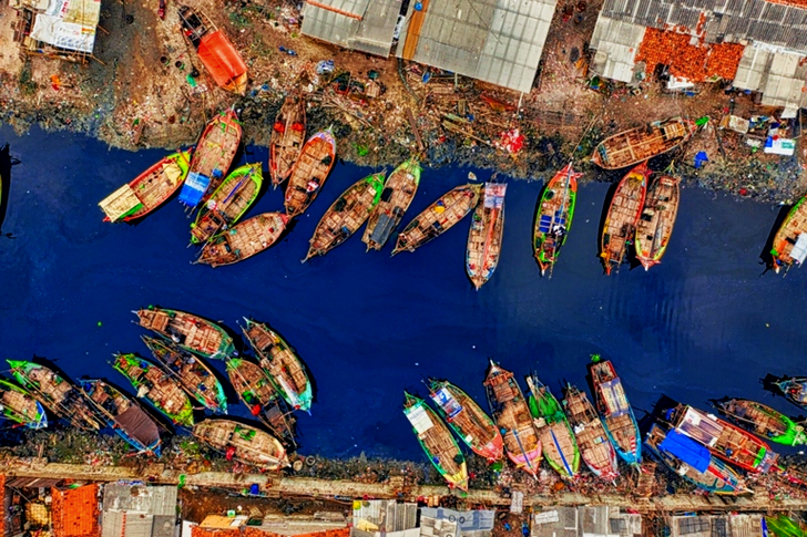 Aerial View of Fishing Boats Docked Along The River