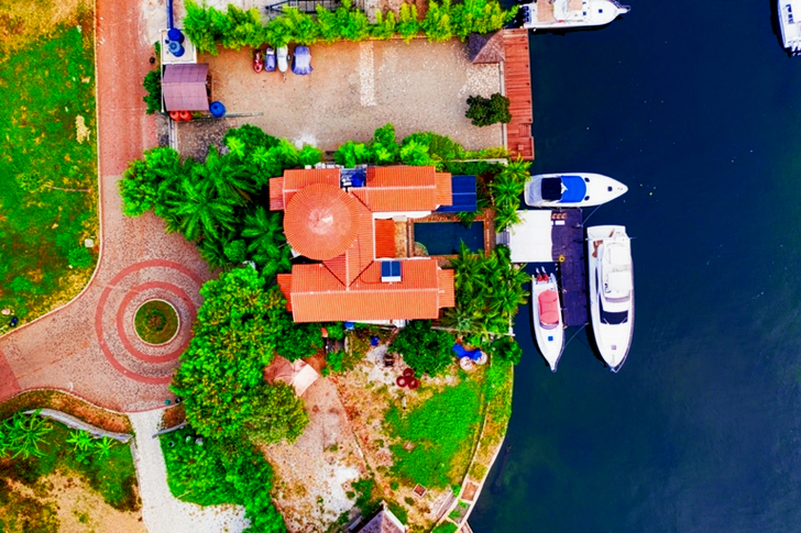 High Angle Three White boats Beside Brown Building