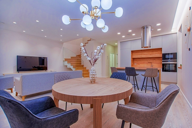 Round Brown Wooden Table With Chairs Inside Room