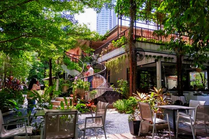Man Standing on a Staircase Outside House