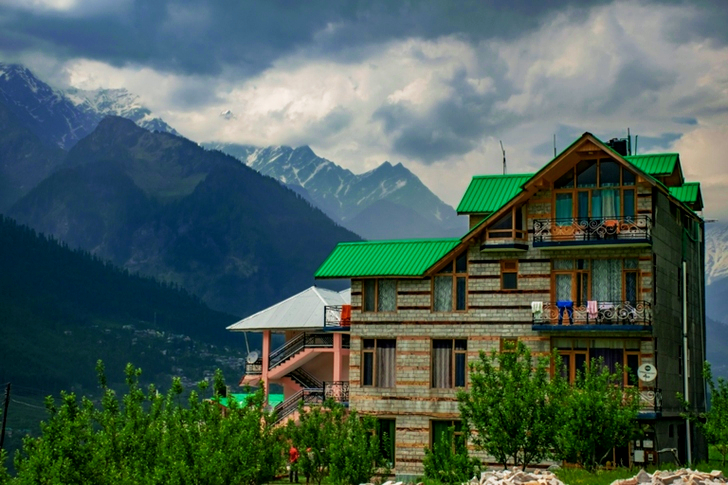 Brown and Green Concrete Building Near Mountains at Daytime
