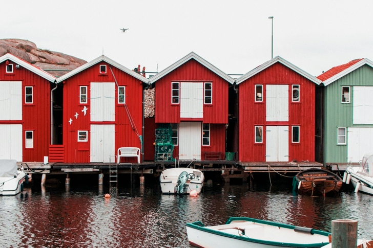 Boats Anchored On A Marina Bay With Houses
