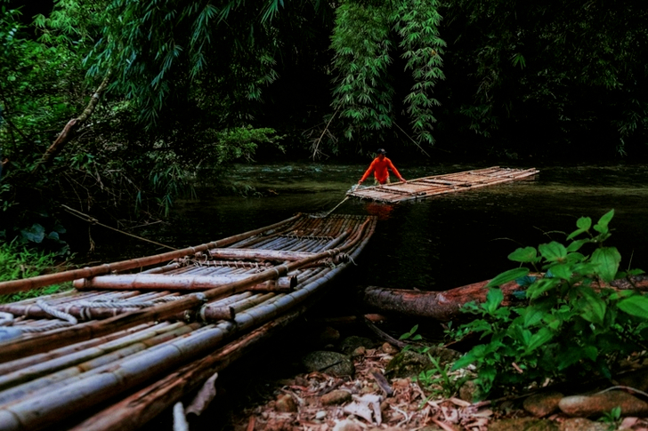 Man Placing A Raft on Body of Water