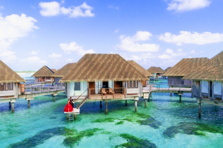 Cluster of Beige Huts Above Water
