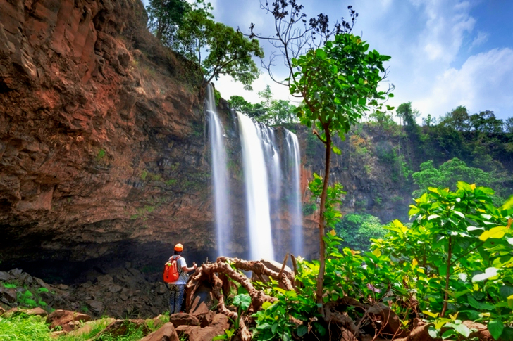 Man Standing in Front of Waterfalls